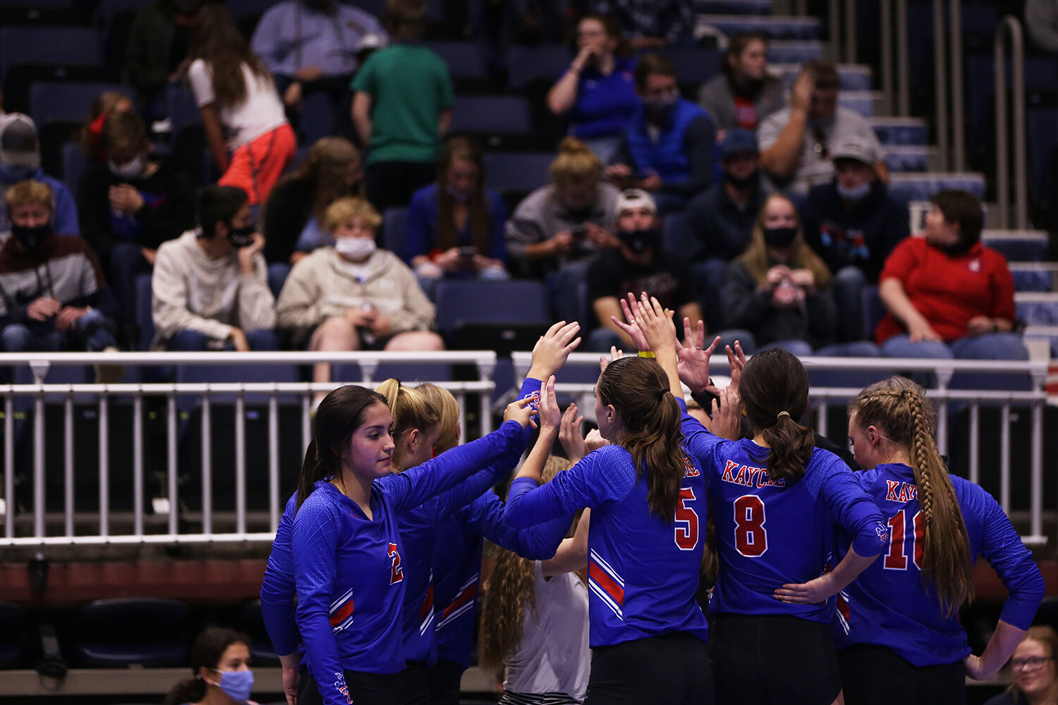 Kaycee High School’s volleyball team huddles together after the conclusion of the second game